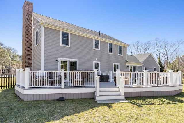 back of house with a yard, a deck, a chimney, and fence