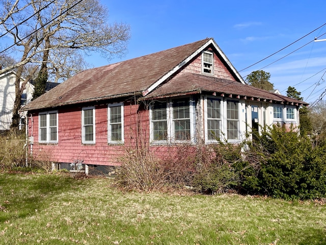 100 Parkwood Dr, Wareham, MA 02571 - view of home's exterior featuring a lawn and roof with shingles