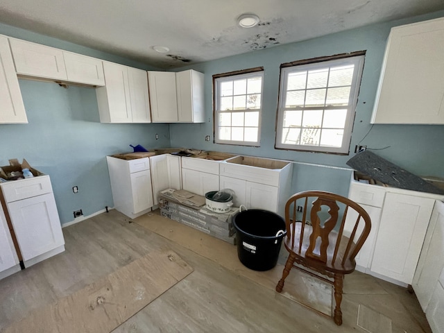 100 Parkwood Dr, Wareham, MA 02571 - kitchen featuring white cabinets and light wood-style flooring