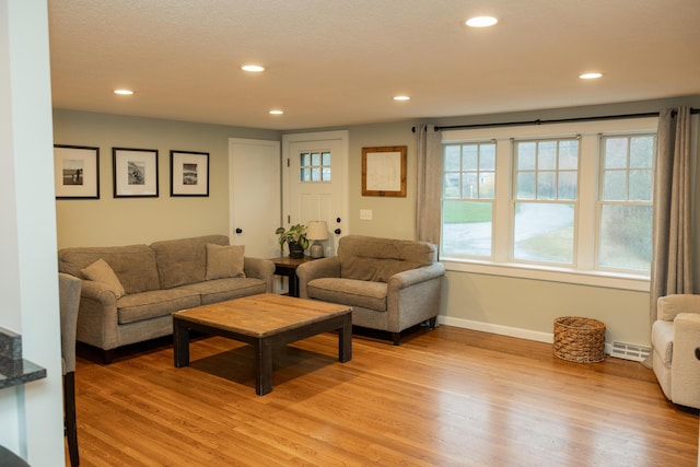 living area featuring recessed lighting, visible vents, baseboards, and light wood-style floors