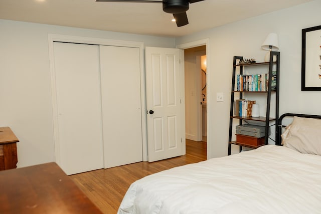 bedroom featuring wood finished floors, ceiling fan, and a closet