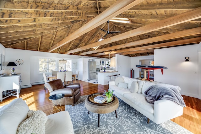 living area featuring baseboards, a baseboard radiator, wood ceiling, wood finished floors, and vaulted ceiling with beams