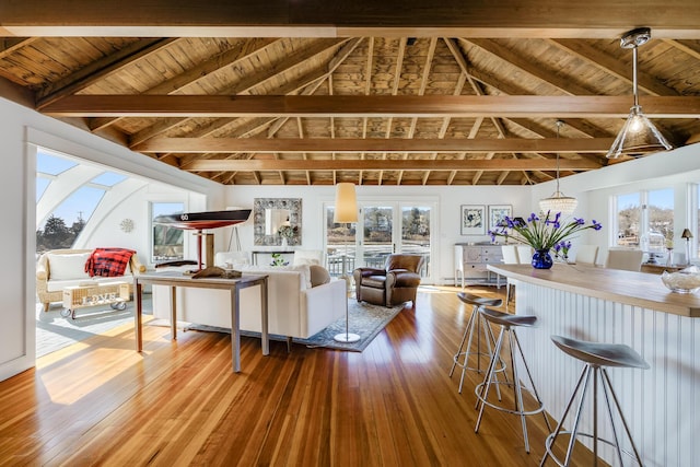 living room with wooden ceiling, a wealth of natural light, and hardwood / wood-style floors