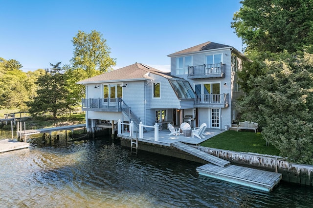 818 S Main St, Centerville, MA 02632 - rear view of property with a balcony, a water view, a lawn, and stairway
