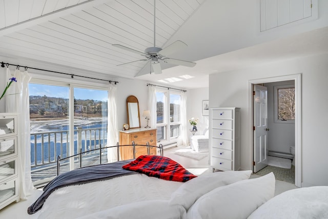 bedroom with a baseboard heating unit, a water view, a ceiling fan, vaulted ceiling, and access to outside