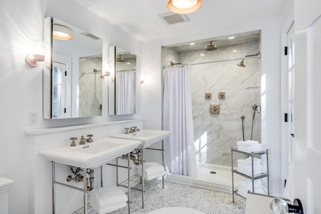 bathroom with a shower stall and visible vents