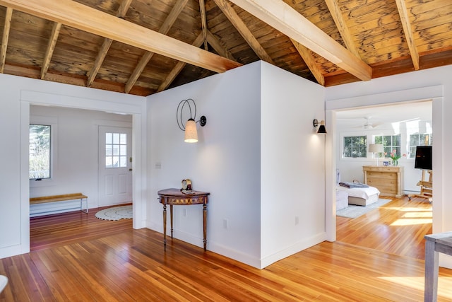 hallway featuring wood ceiling, wood-type flooring, and lofted ceiling with beams