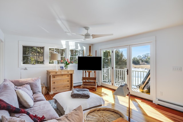 living room featuring ceiling fan, baseboard heating, a baseboard radiator, and light wood-style flooring