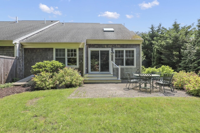 21 Pine St Unit 1Au, North Falmouth, MA 02556 - back of property with entry steps, a patio, a lawn, and a shingled roof
