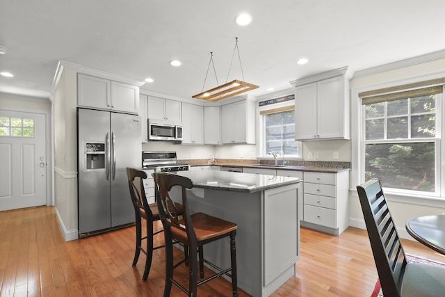 21 Pine St Unit 1Au, North Falmouth, MA 02556 - kitchen with stainless steel appliances, ornamental molding, plenty of natural light, a kitchen bar, and recessed lighting