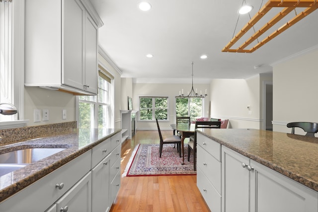 21 Pine St Unit 1Au, North Falmouth, MA 02556 - kitchen featuring recessed lighting, light wood-type flooring, a chandelier, dark stone countertops, and white cabinets