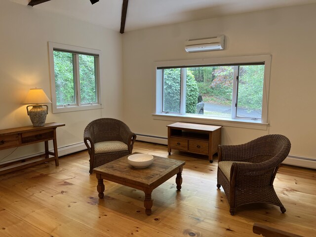 27 Long View Dr, Orleans, MA 02653 - sitting room with a wall mounted air conditioner, a baseboard heating unit, healthy amount of natural light, and light wood-type flooring
