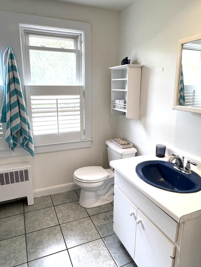 27 Long View Dr, Orleans, MA 02653 - bathroom with radiator, vanity, toilet, and tile patterned flooring