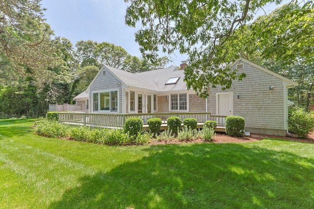21 Gramps Way S, Chatham, MA 02659 - rear view of property with a wooden deck, a chimney, a yard, and roof with shingles