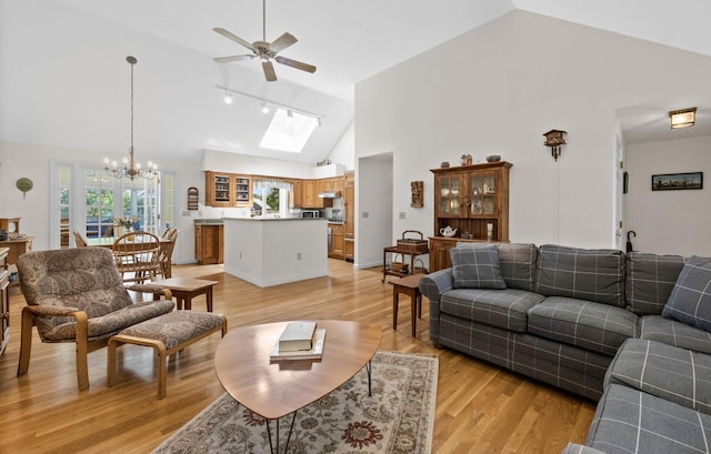 21 Gramps Way S, Chatham, MA 02659 - living room featuring a ceiling fan, light wood-style flooring, a chandelier, a skylight, and high vaulted ceiling