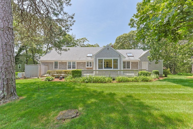 21 Gramps Way S, Chatham, MA 02659 - back of house featuring a lawn, roof with shingles, and a deck