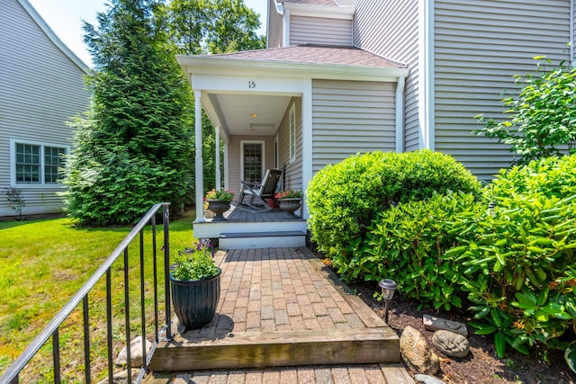 15 Hampton Ct, Mashpee, MA 02649 - doorway to property featuring a yard and a shingled roof