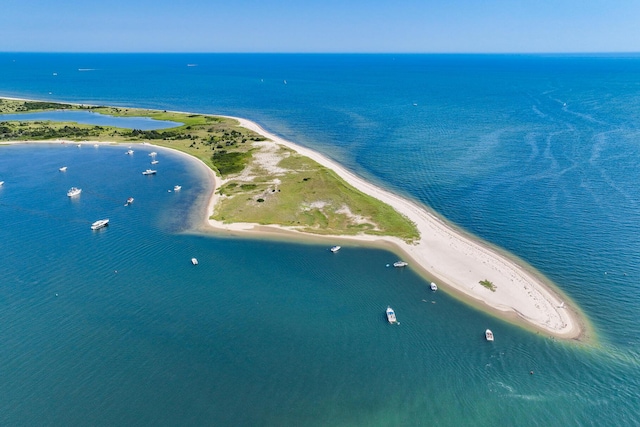 birds eye view of property featuring a water view and a beach view