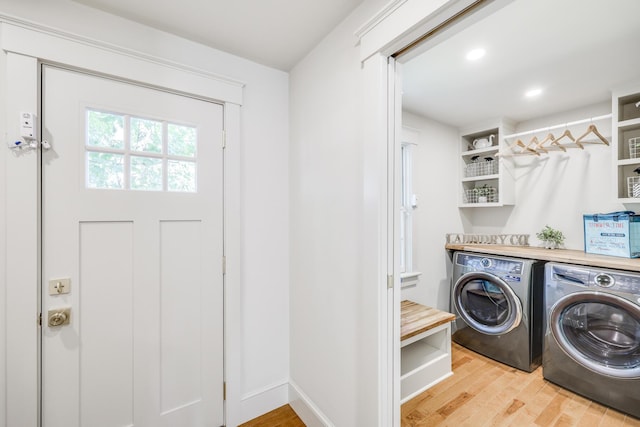 washroom with separate washer and dryer and light hardwood / wood-style flooring