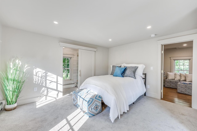 bedroom with a baseboard radiator and carpet floors