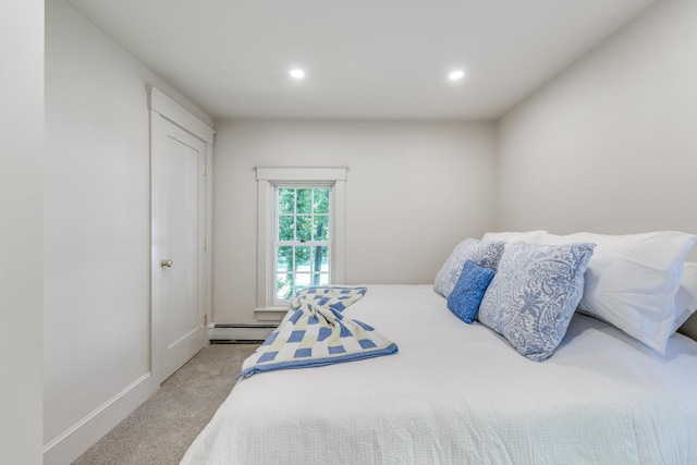 bedroom with a baseboard radiator and light colored carpet