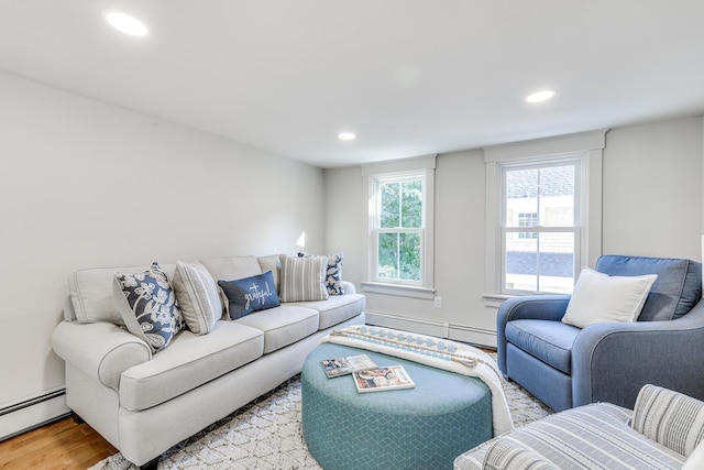 living room with a baseboard radiator and light hardwood / wood-style flooring