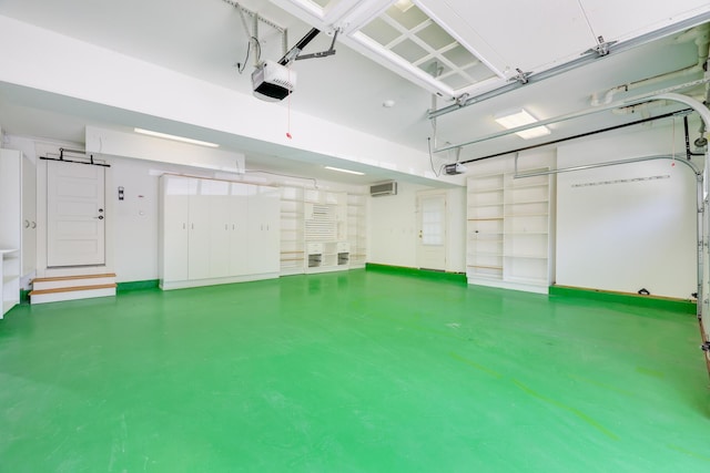 garage with an AC wall unit and a garage door opener