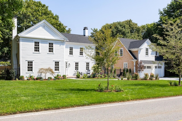 view of front of house with a garage and a front yard