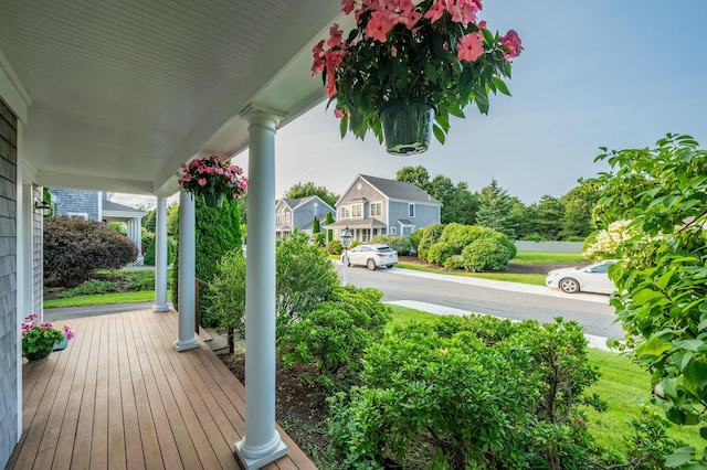 wooden terrace with a residential view and a porch