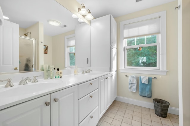 full bath with plenty of natural light, a sink, and tile patterned floors