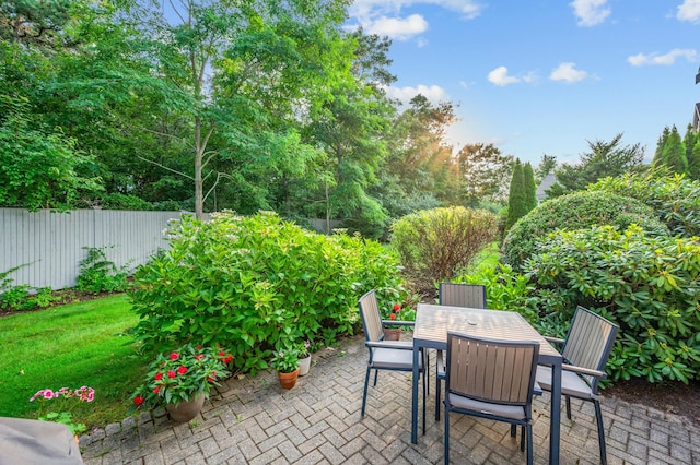 view of patio with fence and outdoor dining area