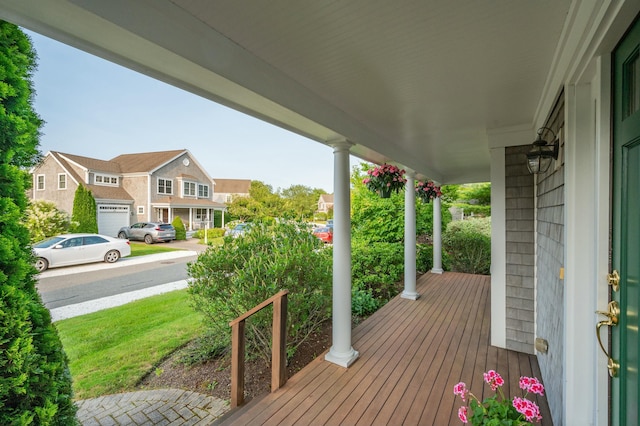 wooden deck featuring covered porch and a residential view