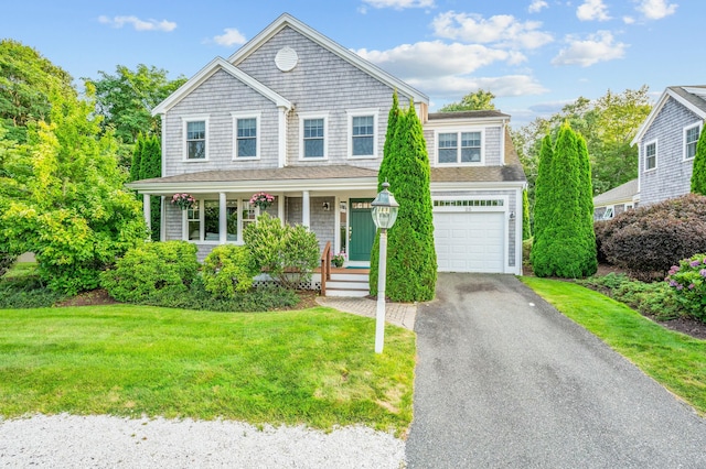 view of front of property featuring a porch, a front lawn, and aphalt driveway