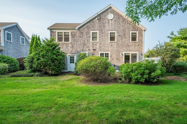 rear view of property with a lawn