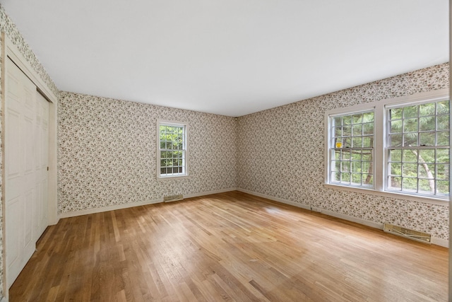 16 John Joseph Rd, Harwich, MA 02645 - unfurnished bedroom featuring wallpapered walls, light wood-style floors, and a closet