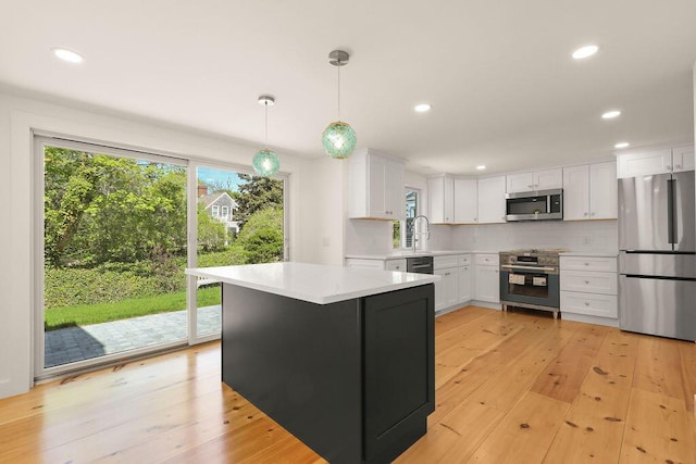 2 Little Cove Ln, Orleans, MA 02653 - kitchen featuring appliances with stainless steel finishes, light countertops, white cabinets, light wood-style flooring, and recessed lighting