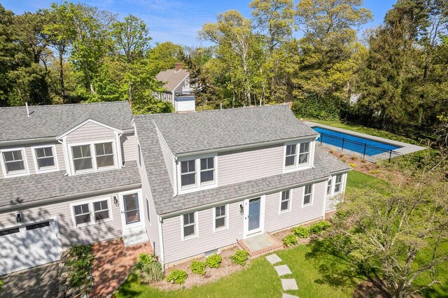 2 Little Cove Ln, Orleans, MA 02653 - view of front of house featuring roof with shingles, view of scattered trees, and a chimney