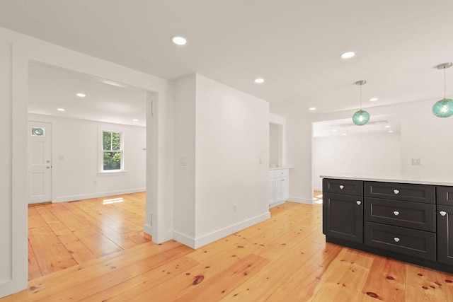 2 Little Cove Ln, Orleans, MA 02653 - kitchen with light wood-style floors, dark cabinets, recessed lighting, hanging light fixtures, and baseboards