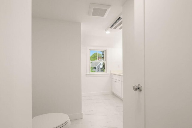 2 Little Cove Ln, Orleans, MA 02653 - bathroom featuring marble look tile flooring, toilet, vanity, and baseboards