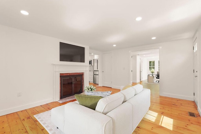 2 Little Cove Ln, Orleans, MA 02653 - living area with light wood-style floors, a brick fireplace, baseboards, and recessed lighting