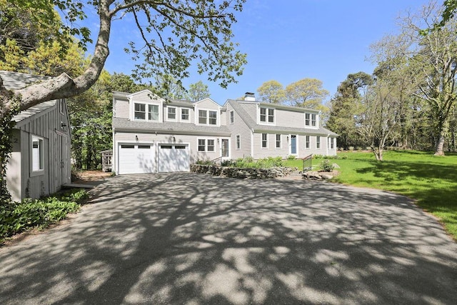 2 Little Cove Ln, Orleans, MA 02653 - view of front of home featuring driveway, a chimney, an attached garage, and a front lawn