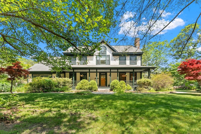 23 Crowell Ln, Tisbury, MA 02568 - view of front facade with covered porch, a front lawn, and a chimney