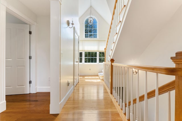 23 Crowell Ln, Tisbury, MA 02568 - hall featuring plenty of natural light, light wood finished floors, high vaulted ceiling, and a chandelier