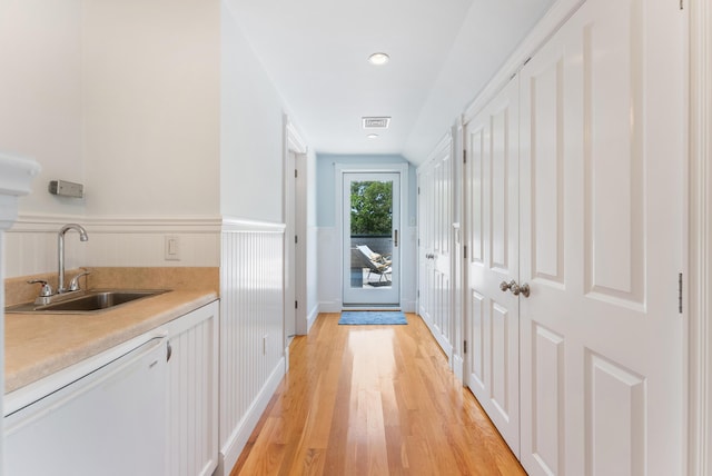 23 Crowell Ln, Tisbury, MA 02568 - hallway with light wood finished floors and a wainscoted wall