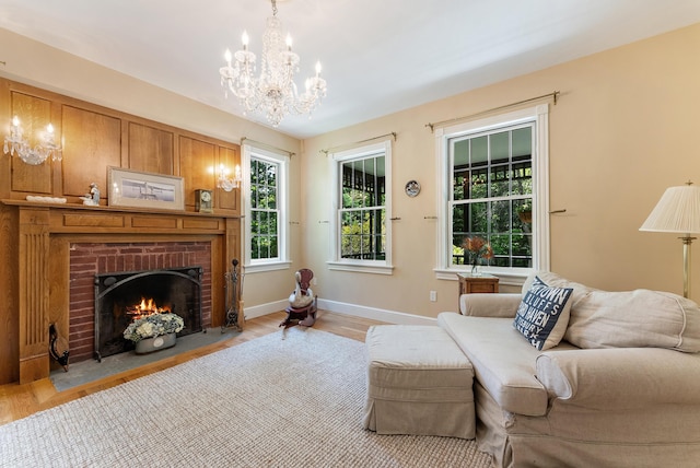 23 Crowell Ln, Tisbury, MA 02568 - living room featuring light wood finished floors, a brick fireplace, and a chandelier