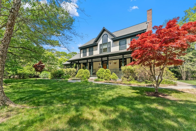 23 Crowell Ln, Tisbury, MA 02568 - view of front of property featuring a porch, a front yard, and a chimney