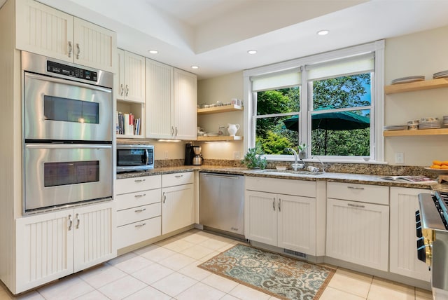 23 Crowell Ln, Tisbury, MA 02568 - kitchen with open shelves, stainless steel appliances, dark stone counters, recessed lighting, and light tile patterned floors