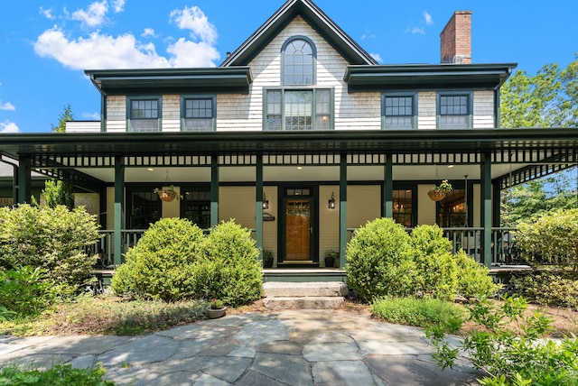 23 Crowell Ln, Tisbury, MA 02568 - view of front of home with covered porch and a chimney
