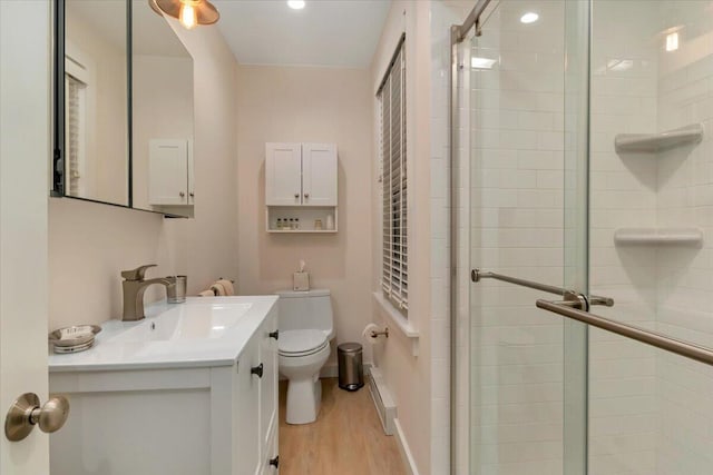 44 Commercial St, Provincetown, MA 02657 - full bathroom with a shower stall, toilet, wood finished floors, and vanity