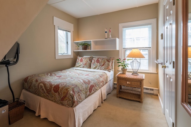 44 Commercial St, Provincetown, MA 02657 - bedroom featuring baseboard heating, multiple windows, and light colored carpet